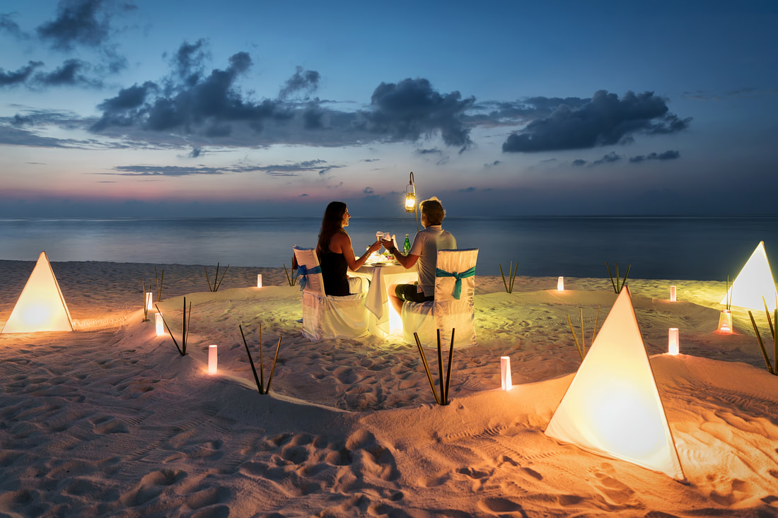 couple having romantic dinner on beach